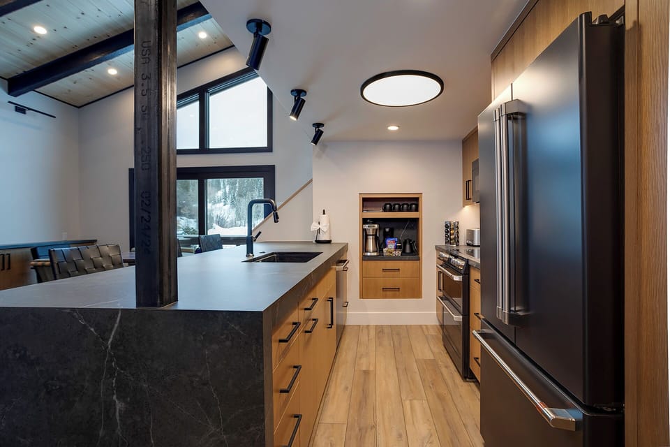 Your gourmet kitchen awaits with sleek countertops, premium appliances, and warm wood cabinetry—perfect for creating memorable meals together.