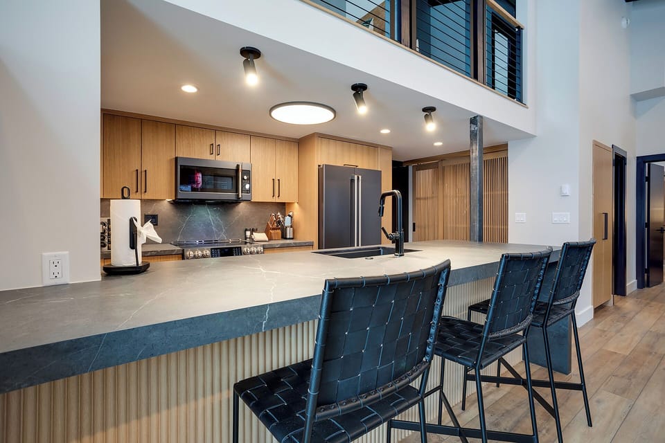 Your gourmet kitchen features sleek appliances and a stunning breakfast bar where you can sip coffee while planning your day.