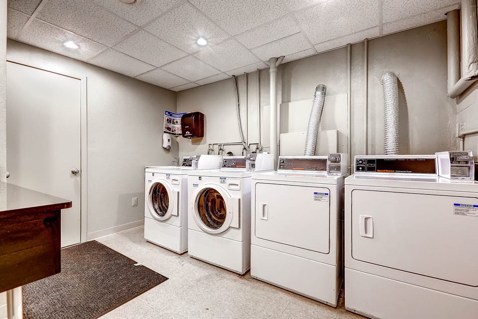 Community laundry room with multiple washers and dryers available for guest use.