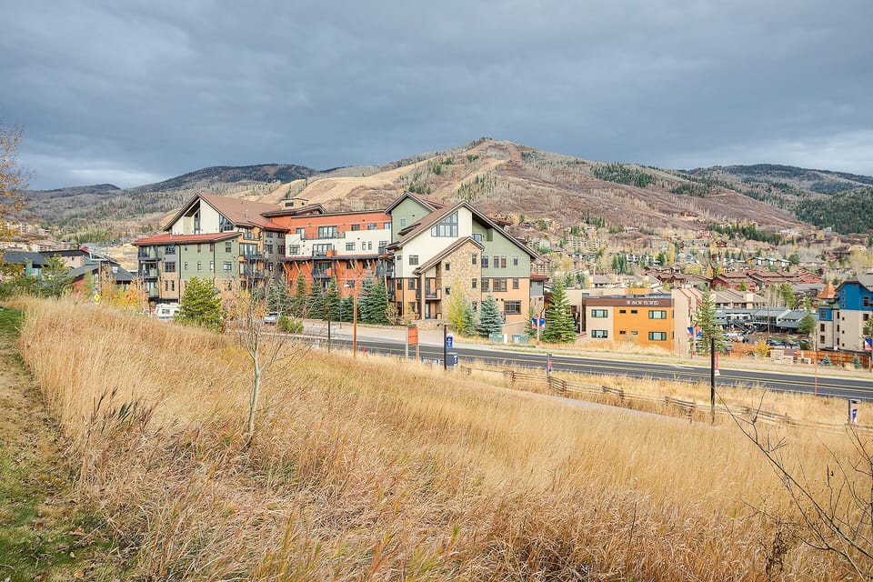 Mountain town setting with rolling hills and residential buildings creating a scenic backdrop for the area.