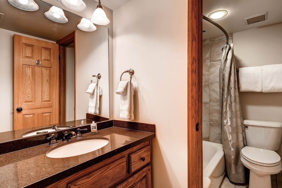 The shared bathroom has a single sink vanity and separate water closet.