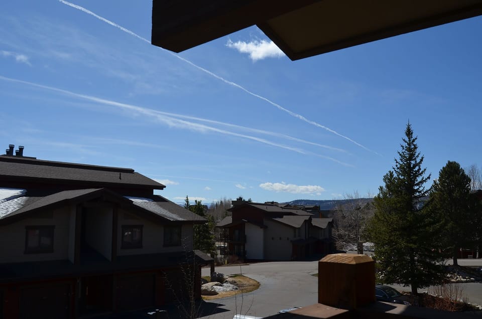 Mountain community setting surrounded by evergreens and open skies, offering a peaceful residential atmosphere.