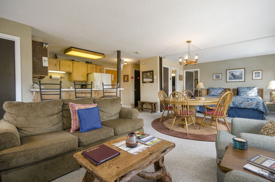 Unwind in your spacious open-plan retreat where cozy seating, a fully equipped kitchen, and comfortable sleeping area create the perfect home base.