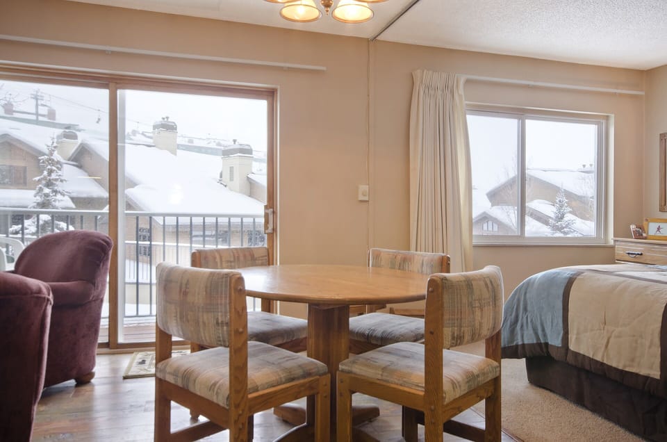 Your cozy mountain retreat features a perfect breakfast nook with snowy views, where you can enjoy morning coffee while watching winter's magic unfold outside.
