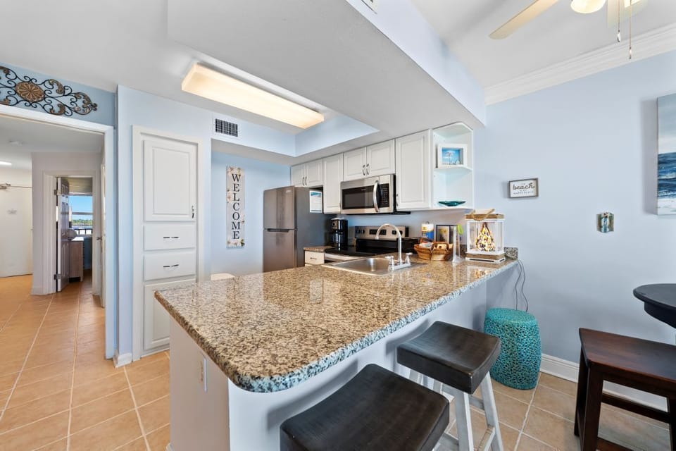 Your fully equipped kitchen welcomes you with granite countertops, modern appliances, and breakfast bar seating for easy meal prep.