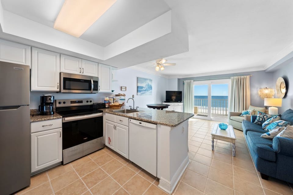 Your oceanfront retreat features a fully equipped kitchen and cozy living area with stunning sea views from your private balcony.