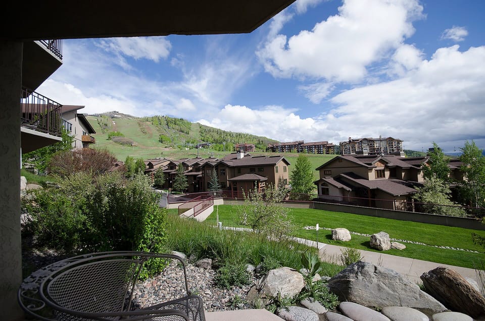 Mountain resort community with ski slopes, landscaped grounds, and alpine architecture nestled in a scenic valley setting.