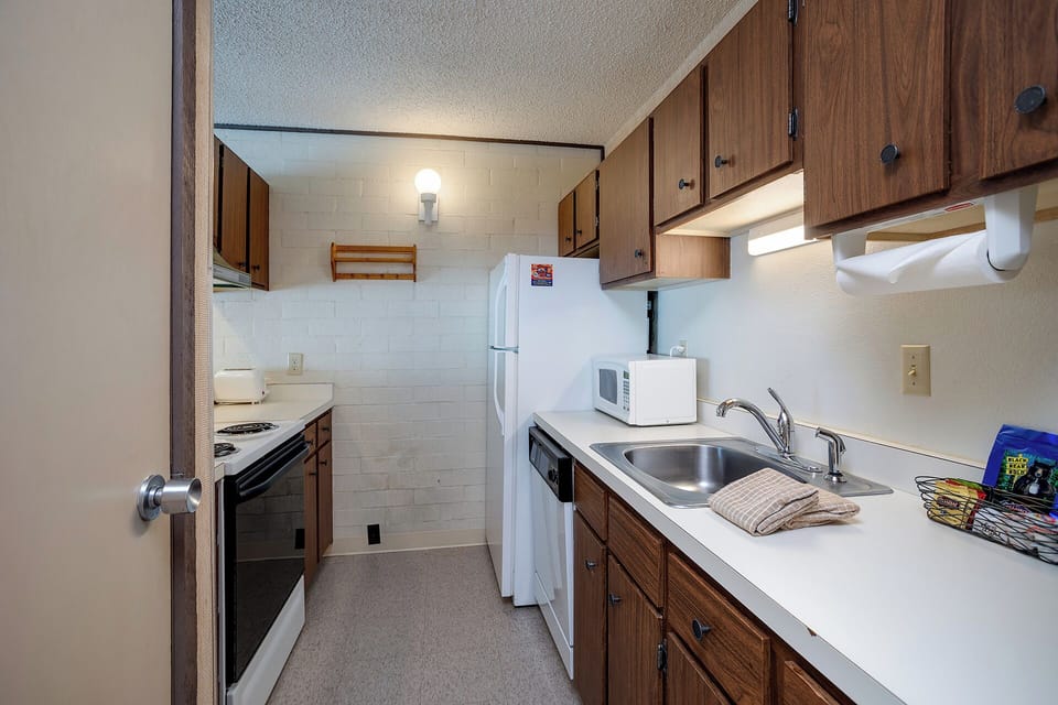 Your fully equipped galley kitchen features warm wood cabinets, modern appliances, and everything you need to prepare meals during your stay.