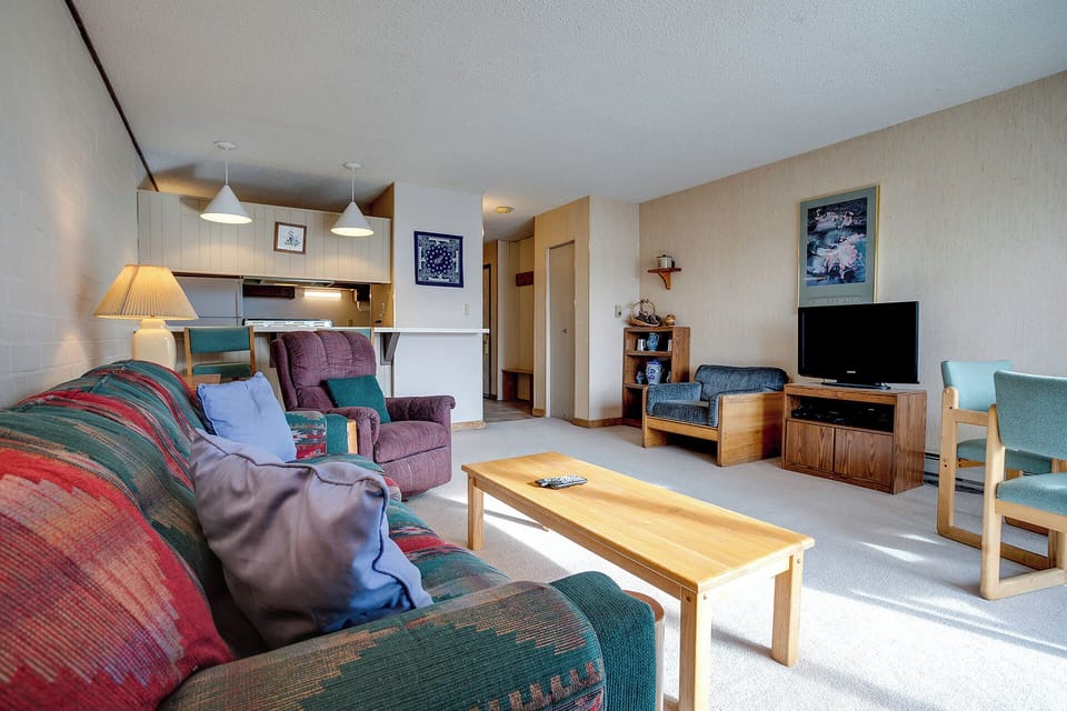 Unwind in your spacious living room with cozy seating, modern kitchen, and entertainment center—perfect for relaxing after mountain adventures.