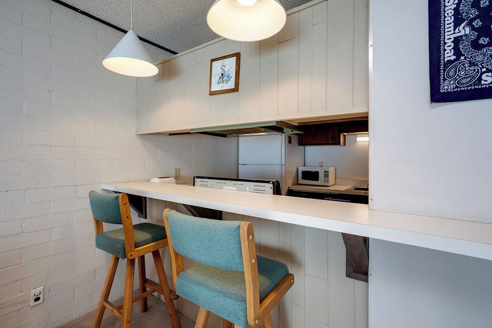 Your stylish kitchen bar invites morning coffee and casual meals with mid-century charm and modern convenience.