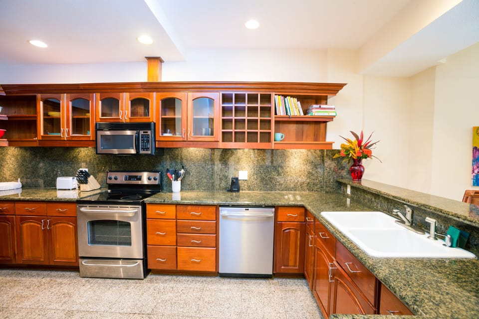 Modern open kitchen with breakfast bar with additional breakfast bar seating
