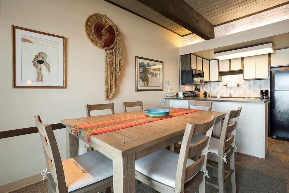 Gather around this beautiful dining table where rustic beams meet modern comfort, creating the perfect space for your group meals and vacation memories.