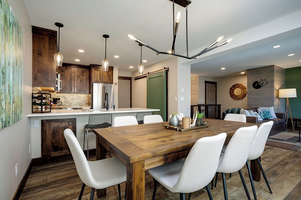 Gather around this stunning dining table where rustic wood meets modern comfort, creating the perfect spot for your memorable meals together.