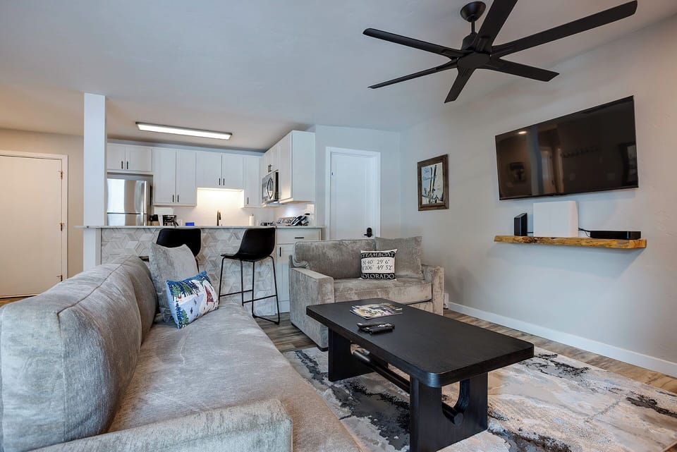 Unwind in your modern open-concept space with plush seating, fully equipped kitchen, and entertainment center—perfect for relaxing evenings.