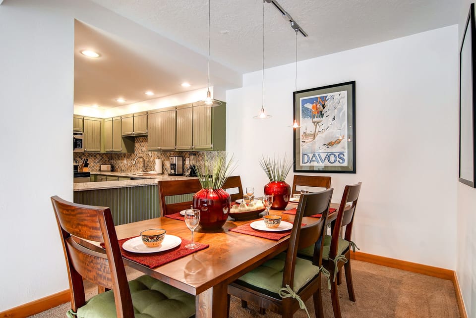 A wooden dining table for 6 guests with stylish furnishings.