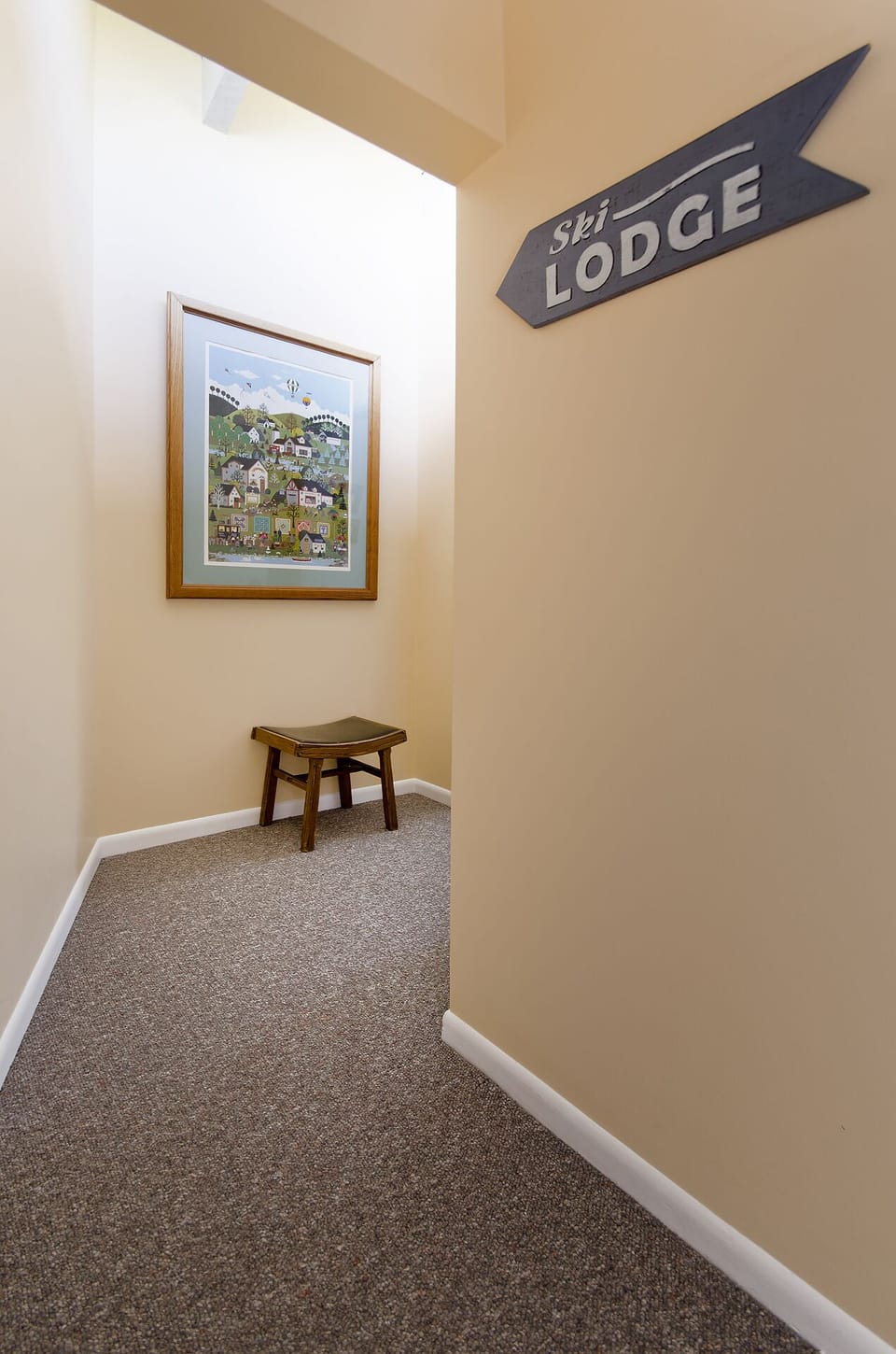 Step into your cozy ski lodge retreat, where rustic charm meets comfort with thoughtful touches like local artwork and warm seating areas.