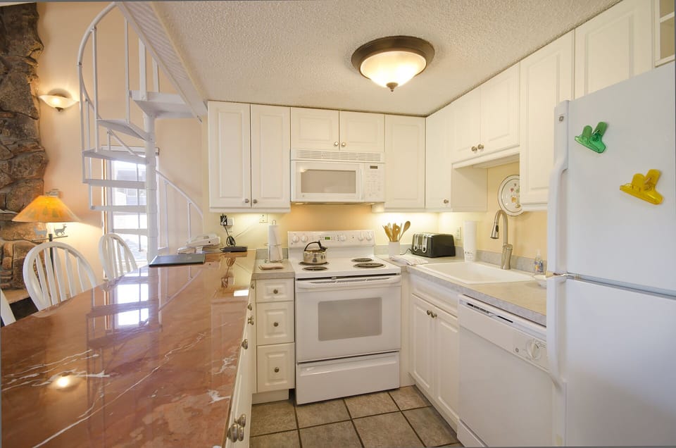 Your bright, fully-equipped kitchen features marble countertops and everything you need to prepare memorable meals during your stay.