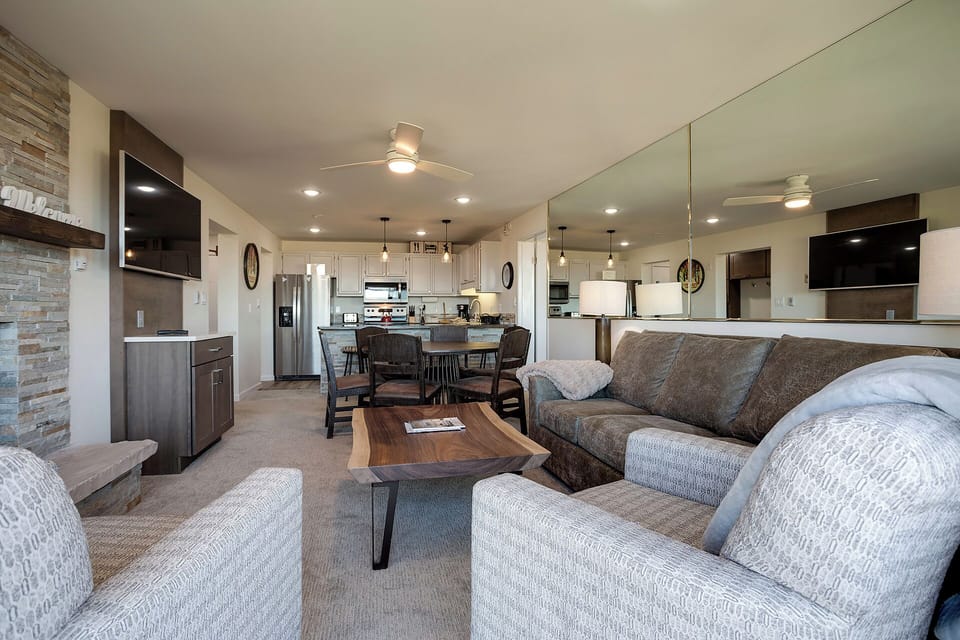 Sink into plush sofas while enjoying your open-concept living space with modern kitchen and stylish dining area.