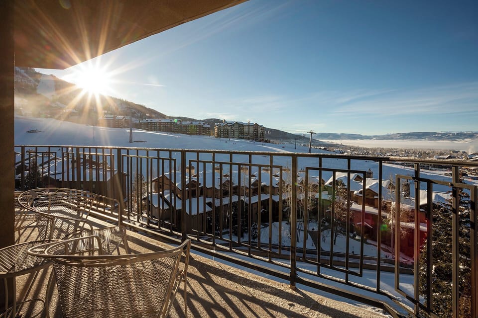 Bright morning sun creates stunning mountain views from this private balcony, where you can sip coffee while enjoying panoramic ski resort vistas.