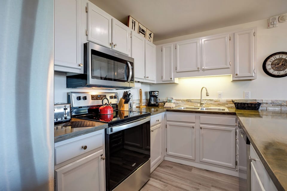 Cook your favorite meals in this bright, fully-equipped kitchen with modern appliances and ample counter space for all your culinary adventures.