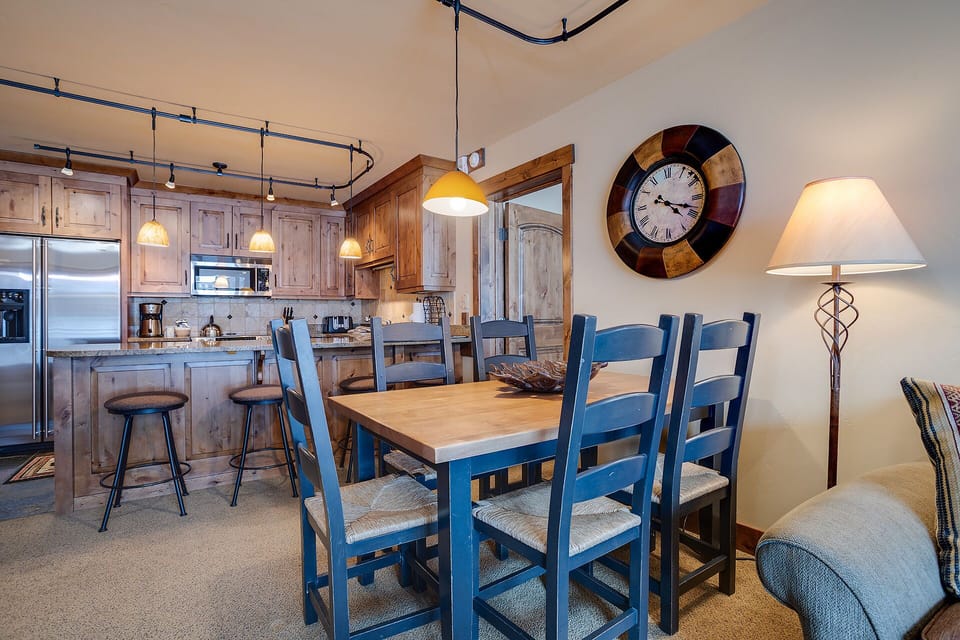 Your mountain-style dining space flows seamlessly into the fully equipped kitchen, perfect for sharing memorable meals together.