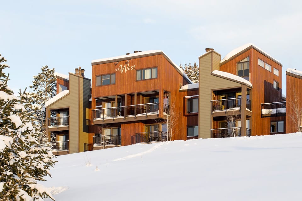 Modern alpine lodges nestled in fresh powder, featuring warm wood exteriors and private balconies for mountain retreats.