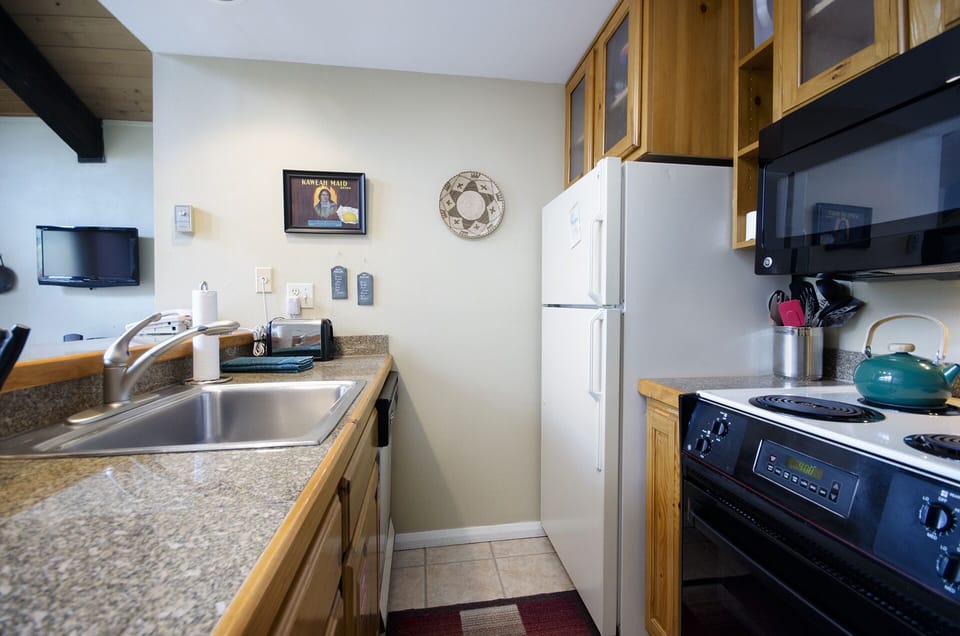Your fully equipped kitchen awaits with everything needed to prepare meals, from granite counters to modern appliances and charming wood cabinetry.