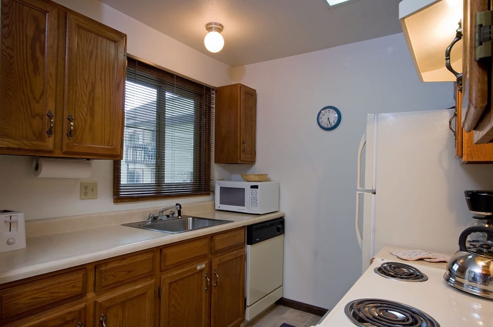 Your fully equipped kitchen features warm wood cabinets, all essential appliances, and plenty of counter space for preparing your favorite meals.
