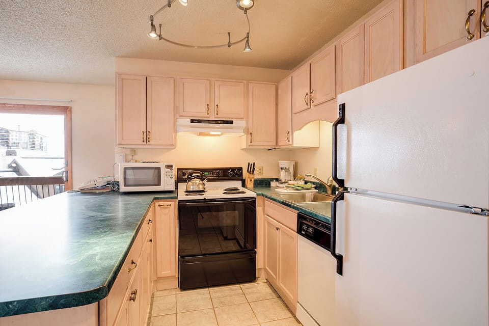 Your fully equipped kitchen makes meal prep a breeze with ample counter space, modern appliances, and warm wood cabinetry.