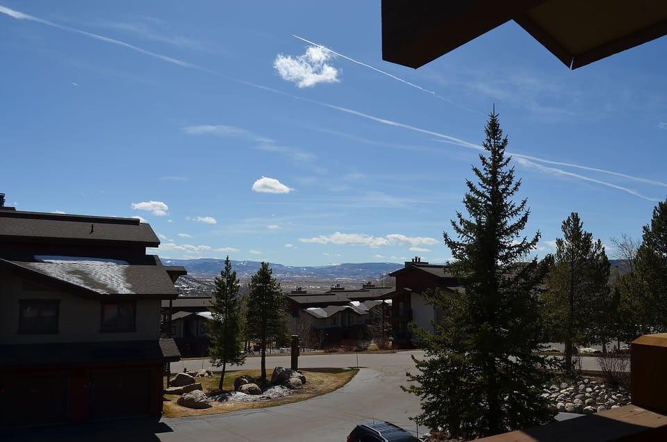 Mountain resort setting with stunning valley views and evergreen landscapes surrounding the property buildings.