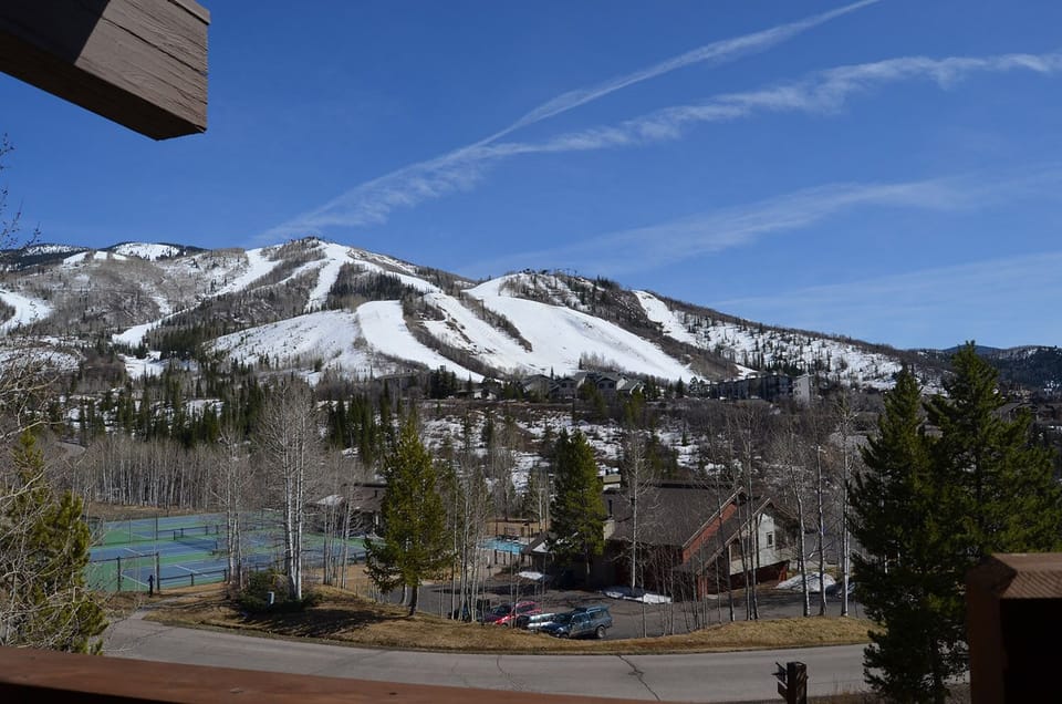 Stunning winter mountain vistas with snow-covered ski slopes dominating the landscape beyond the property.