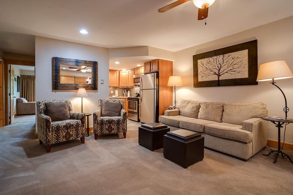 Unwind in your spacious living area with plush seating and a fully equipped kitchen, perfect for cozy evenings in.