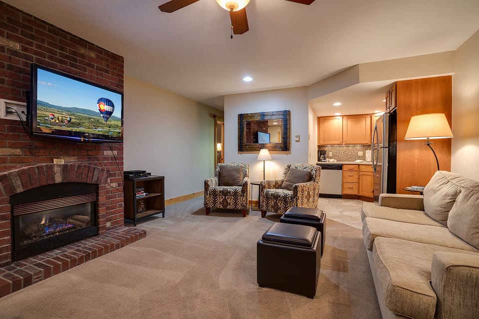Sink into plush seating while the fireplace crackles and your favorite shows play on the large TV in this inviting living space.