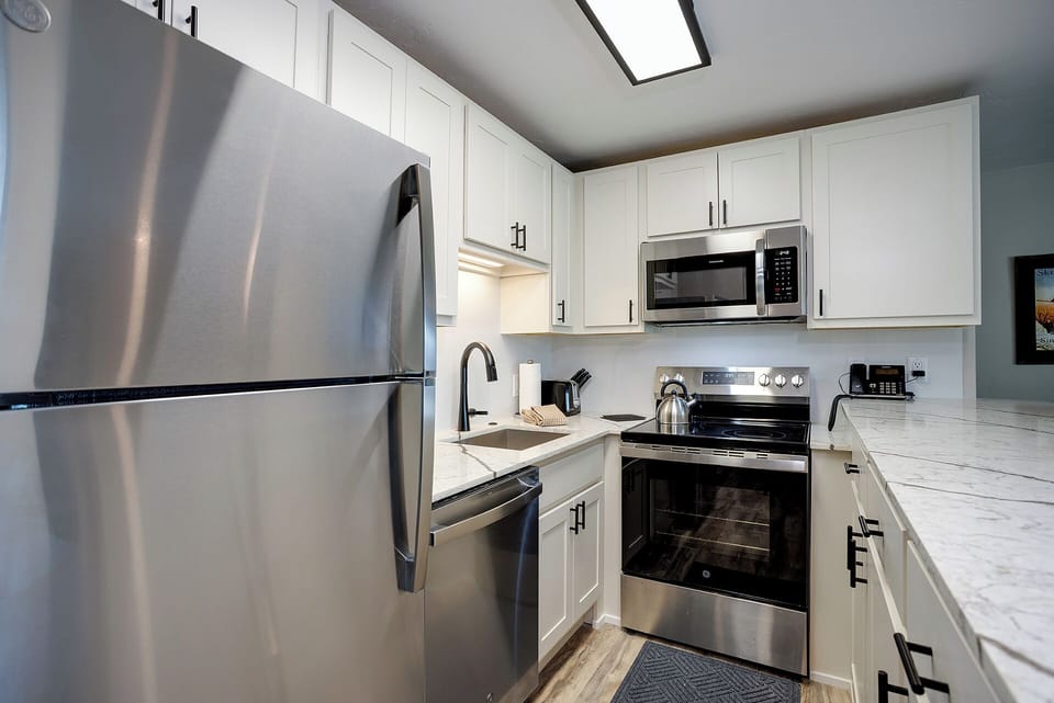 Your fully equipped kitchen features stainless steel appliances and pristine countertops for effortless meal preparation.
