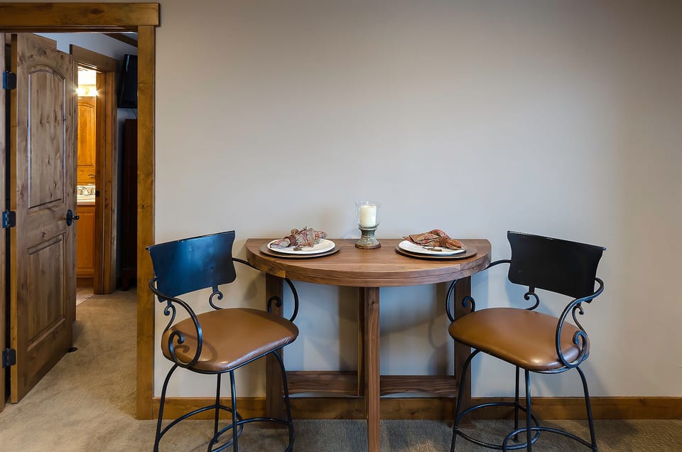 Savor intimate meals at your cozy wooden dining table, perfectly set for romantic dinners or morning coffee together.