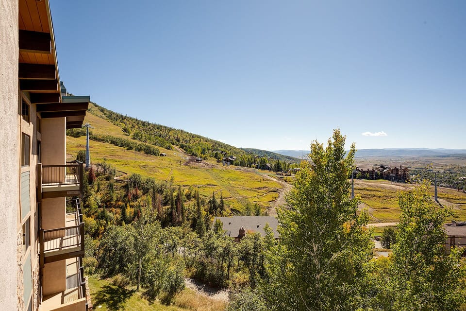 Mountain resort with stunning alpine views and balconied accommodations nestled in rolling hills.