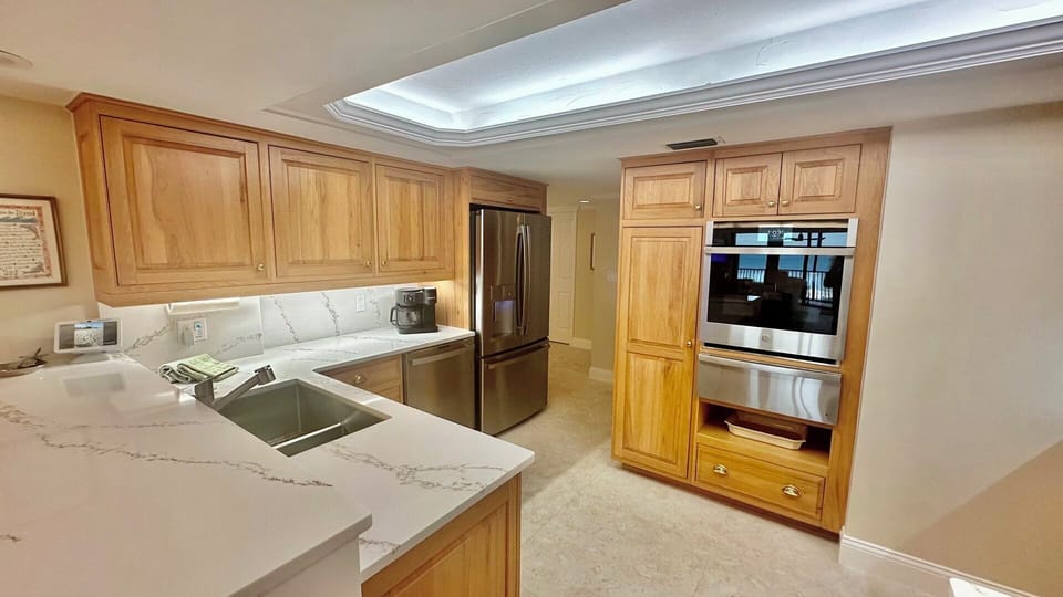 The kitchen features custom Crystal Ash cabinetry and wifi appliances.