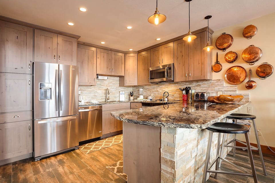 Your gourmet kitchen awaits with granite countertops, stainless steel appliances, and copper accents creating the perfect space for culinary adventures.