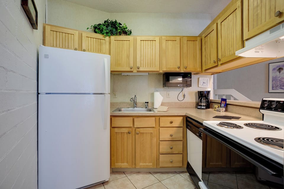 Your fully equipped kitchen features warm wood cabinets, full-size appliances, and everything you need to prepare meals during your stay.