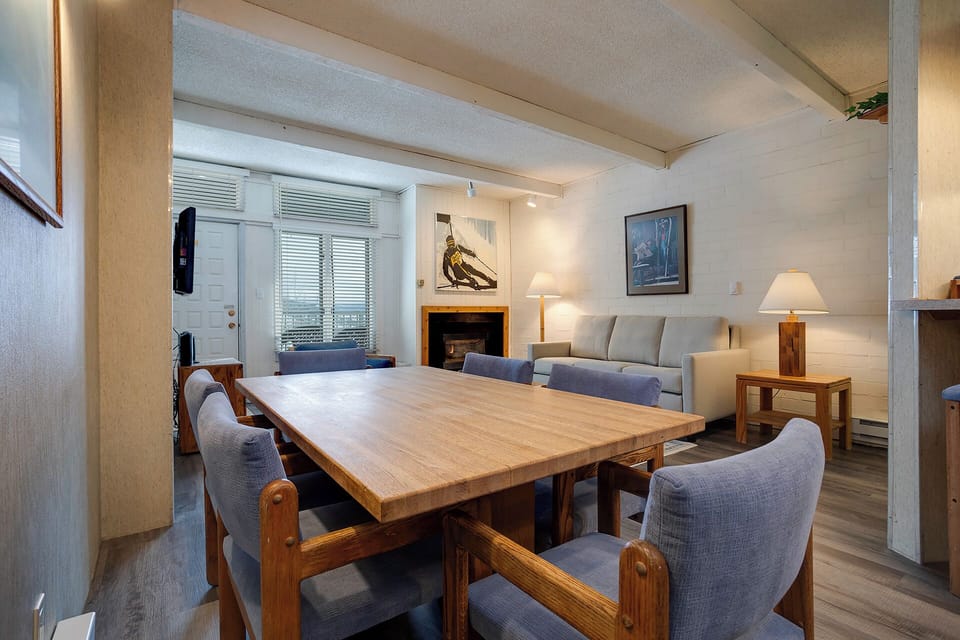 Cozy up in your rustic-chic dining space, where warm wood meets modern comfort for memorable meals with loved ones.