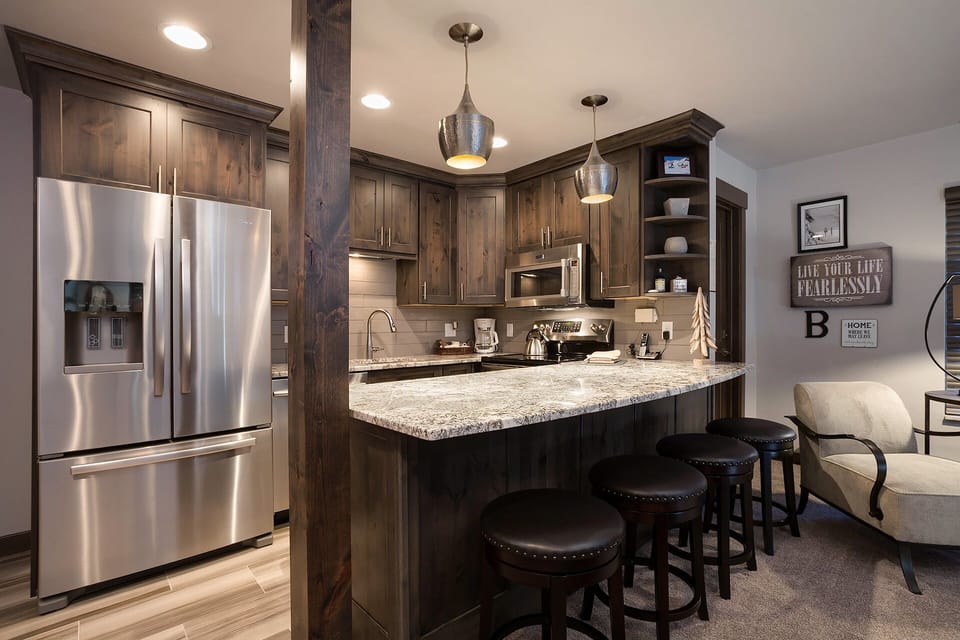 Your stylish kitchen features rich wood cabinetry, granite counters, and stainless steel appliances for memorable meal prep.