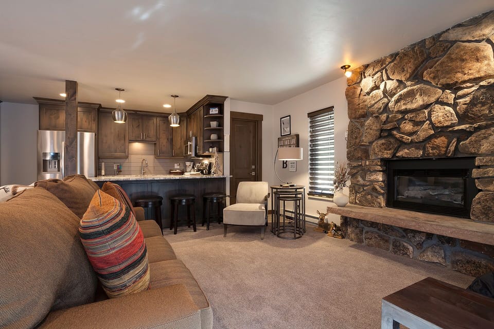 Cozy up by your stone fireplace while preparing meals in your fully equipped kitchen with stainless appliances.
