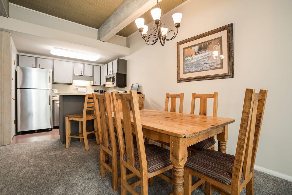 Gather around this rustic dining table where your group can share meals and make memories in this charming space.