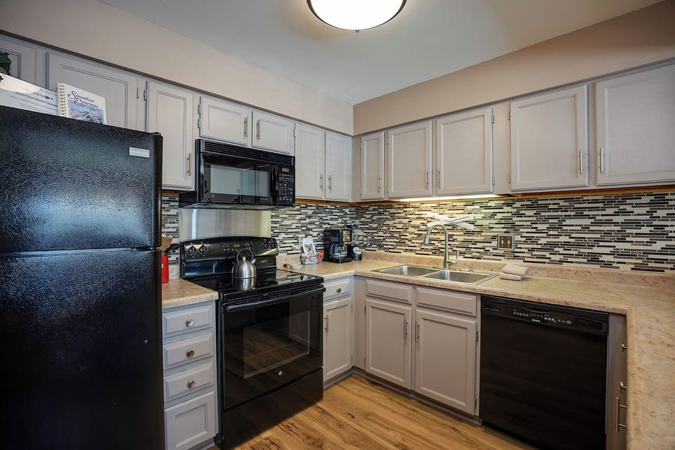 Your fully equipped kitchen features modern appliances, granite countertops, and a stylish mosaic backsplash for memorable home-cooked meals.