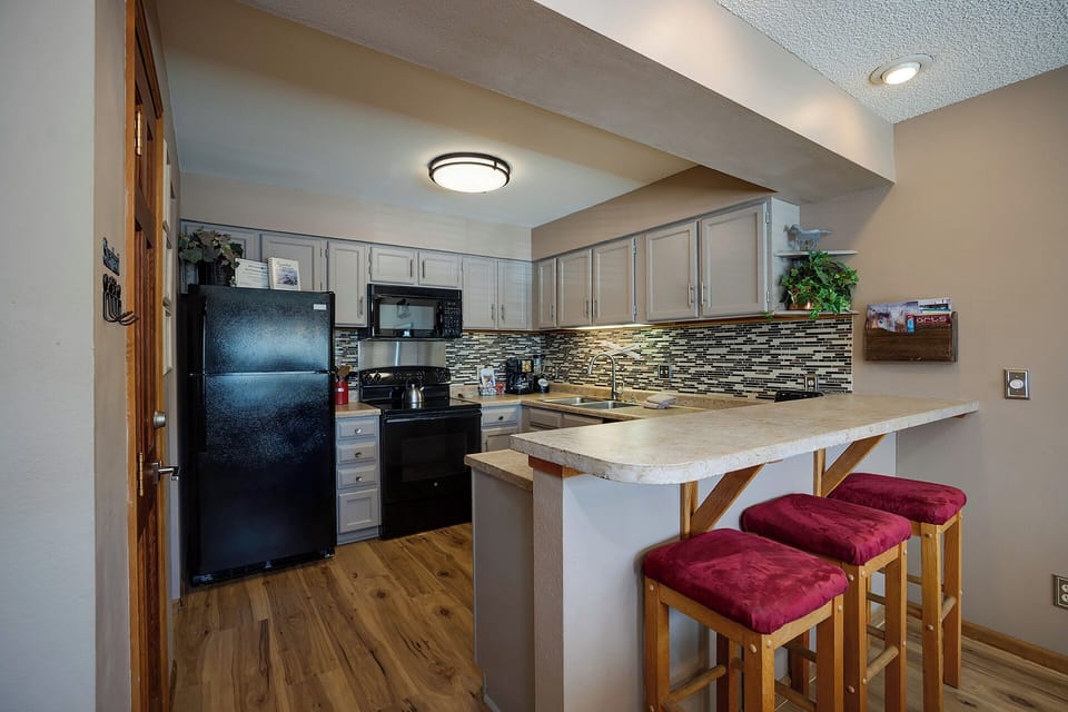 Your fully-equipped kitchen features modern appliances, granite counters, and a breakfast bar where you can enjoy morning coffee or casual meals together.