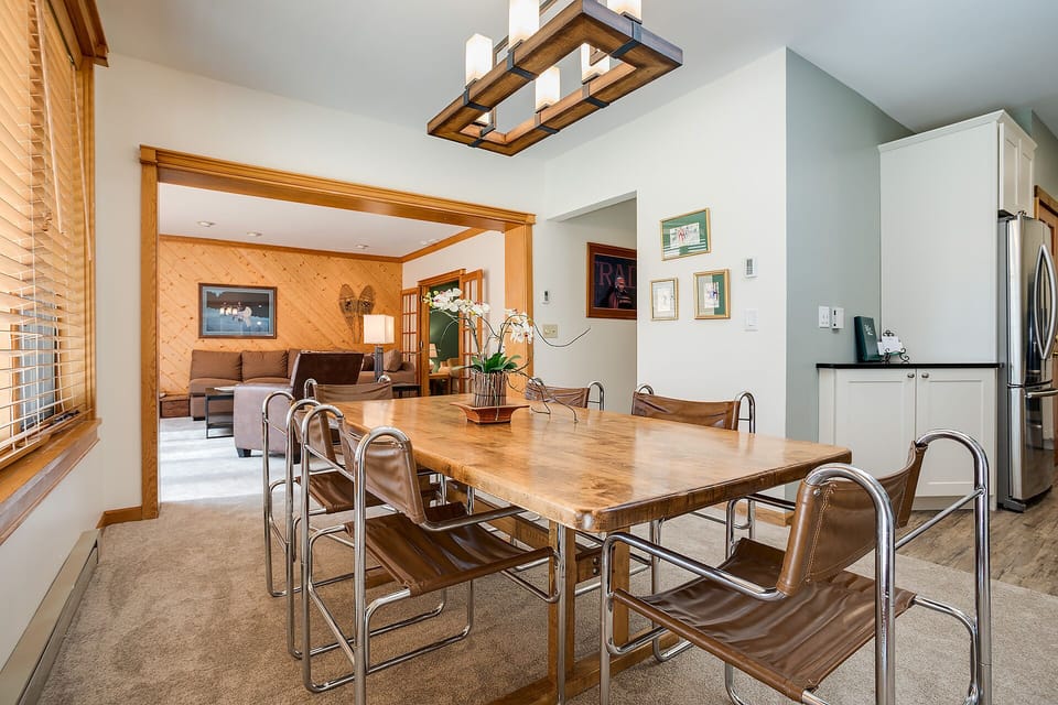 Gather around this stunning wood dining table where your group can share memorable meals together in this bright, thoughtfully designed space.