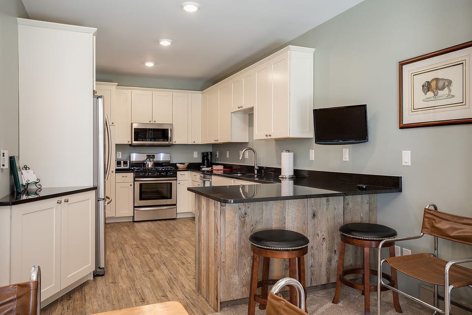 Your spacious kitchen features granite countertops, stainless appliances, and a breakfast bar where you can enjoy morning coffee.