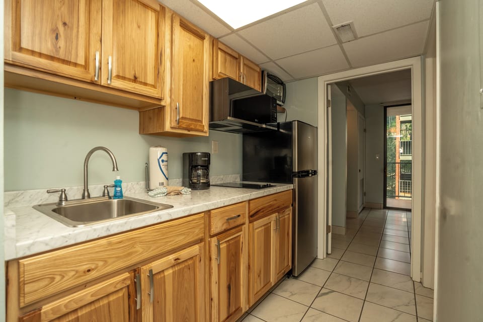 Your well-equipped kitchen features warm wood cabinets, stainless appliances, and everything needed to prepare your favorite meals during your stay.