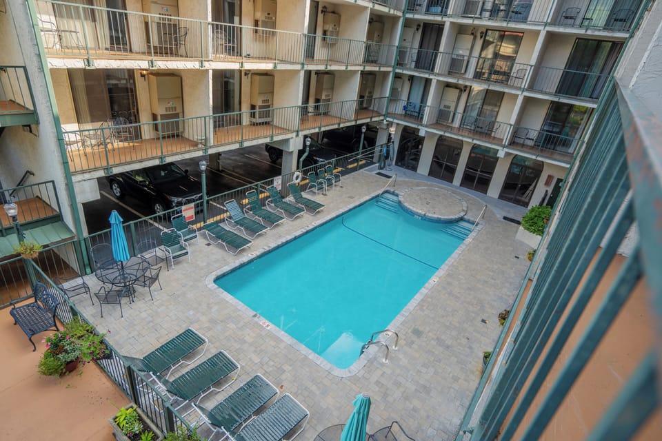 This tranquil courtyard pool offers your private escape from the city, surrounded by multiple levels of balconied units. Enjoy sunbathing on the lounge chairs or relaxing under the poolside umbrellas.