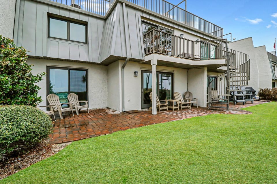 Backyard Patio (lower level) - Unit is ground level. Lovely grounds and easy access to the beach!